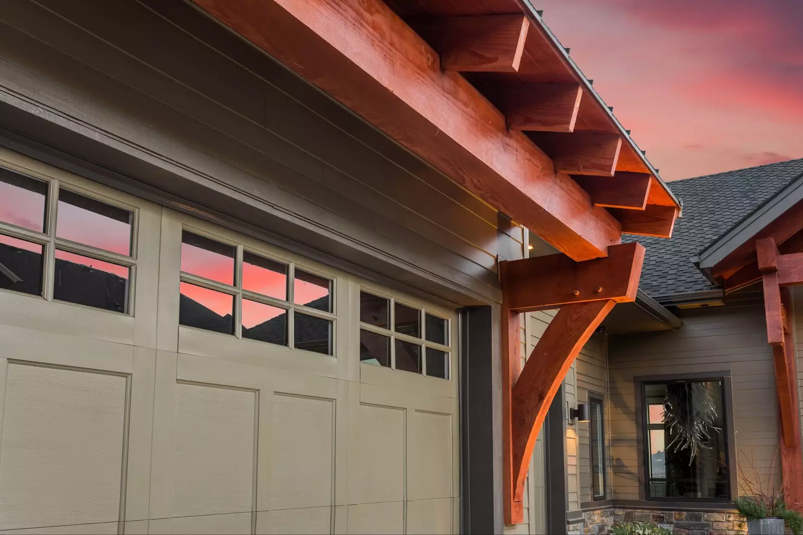 A house featuring a garage door under a striking red sky, symbolizing the importance of garage door replacement.