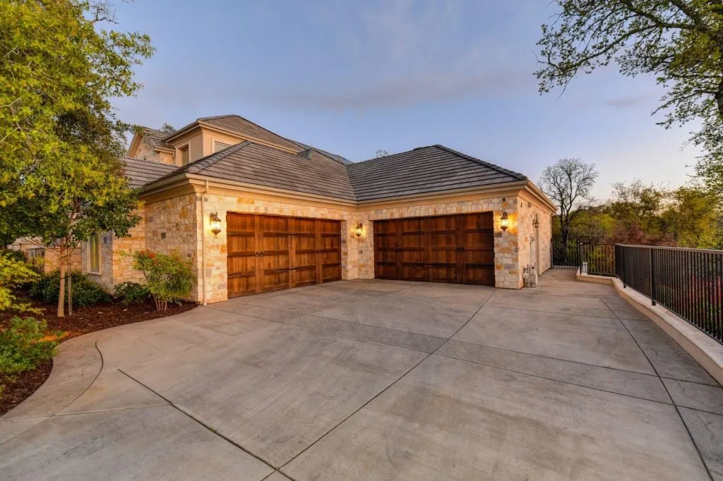 A spacious garage featuring two large doors designed for easy access and ample storage